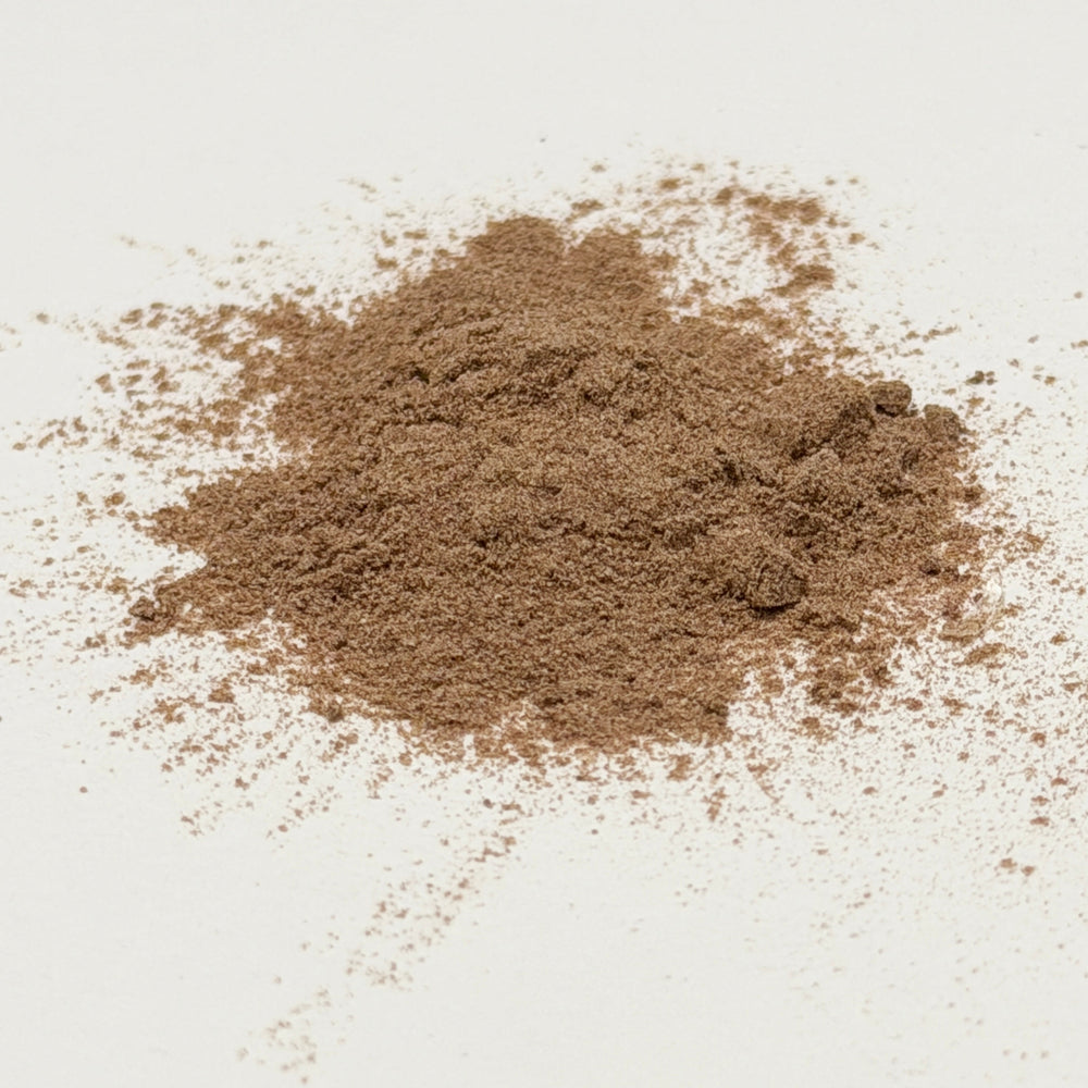 Brown powder on white background. CoQ10 powder highlight