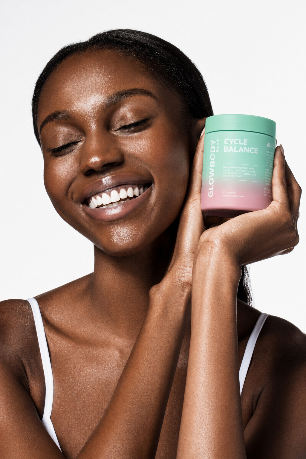 Woman holding the Glowbody Supps Cycle Balance supplement container against a white background. 