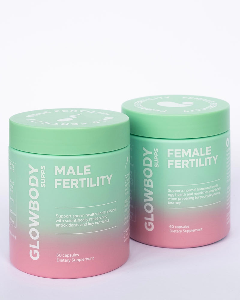 Two supplement jars labeled 'Female Fertility & Male Fertility' by Glowbody Supps on a light background