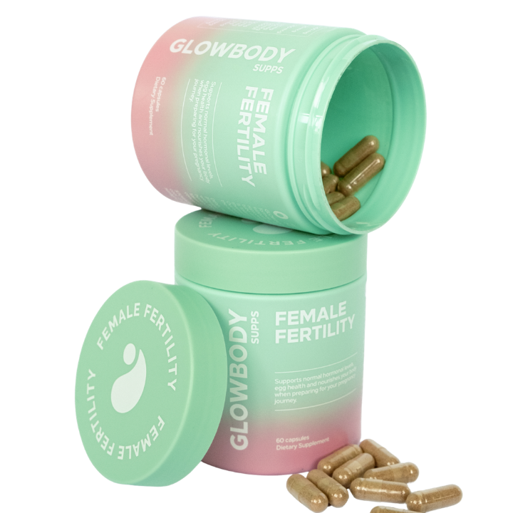 Glowbody Supps Female Fertility supplement containers with capsules on a white background